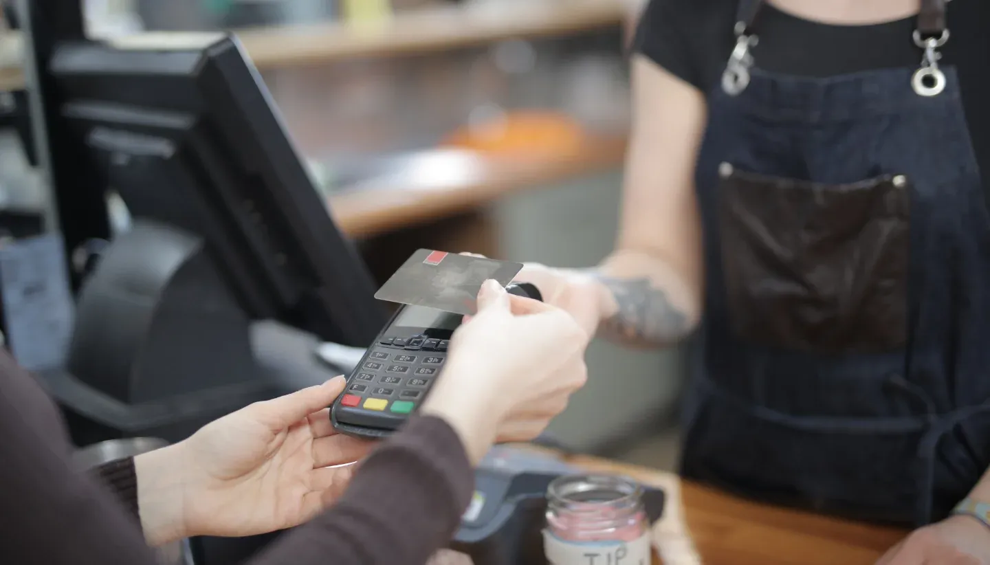 Woman paying with credit card at cashier