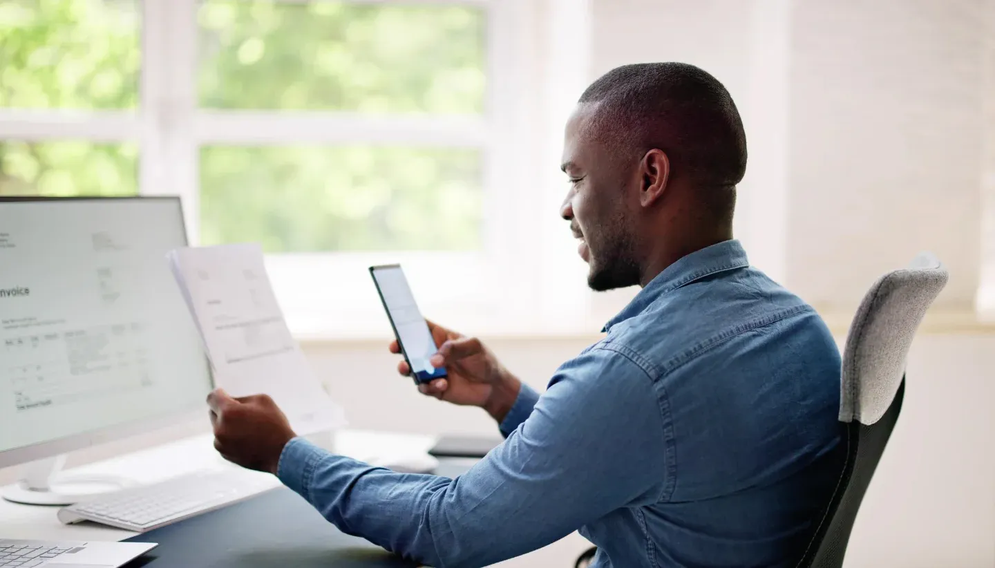 Man scanning a document using his mobile phone