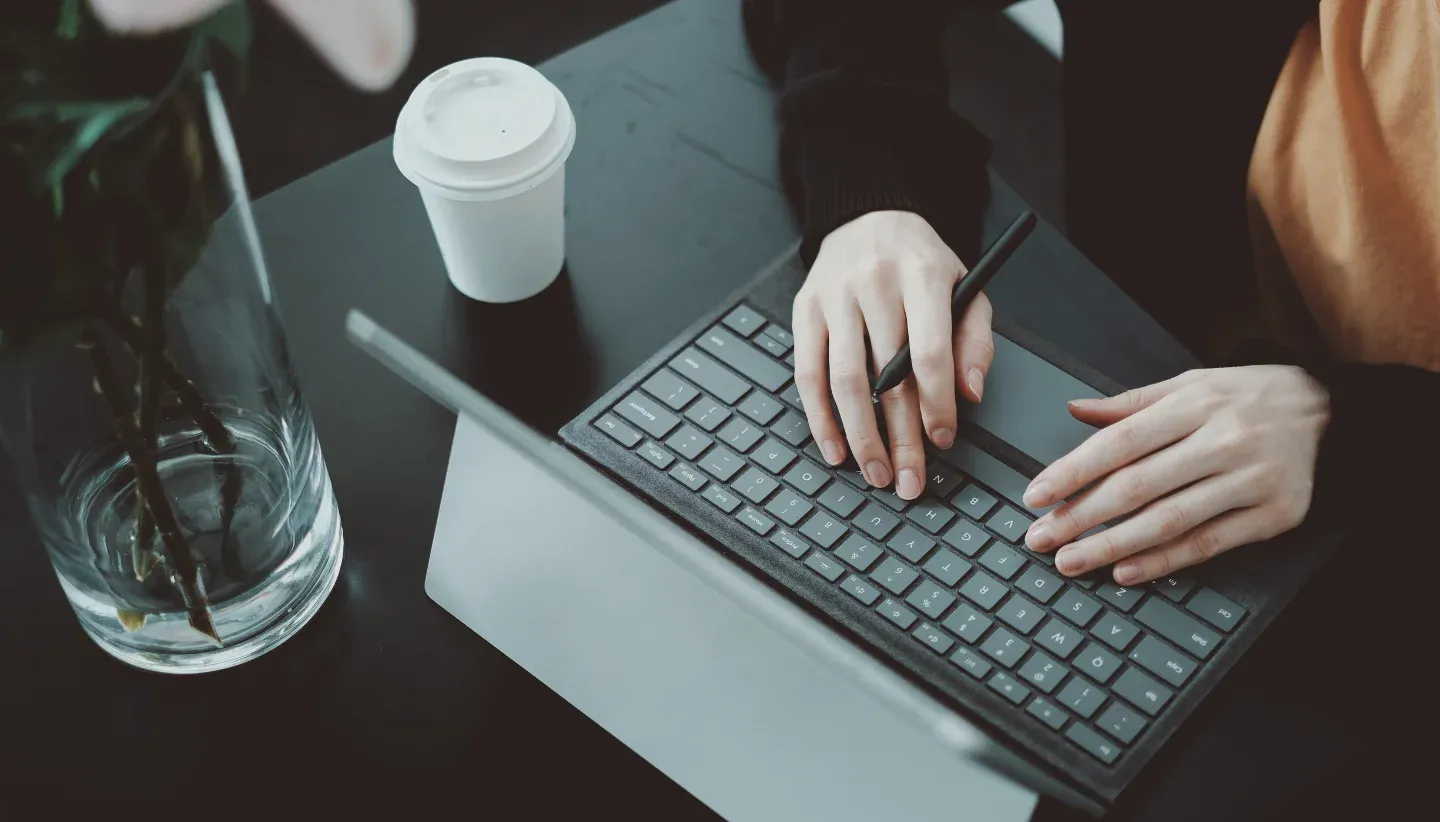 A woman's hands on her tablet keyboard