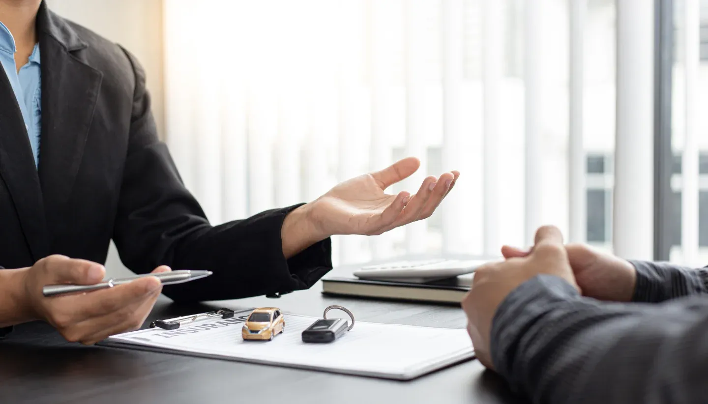 Two people transacting on car insurance